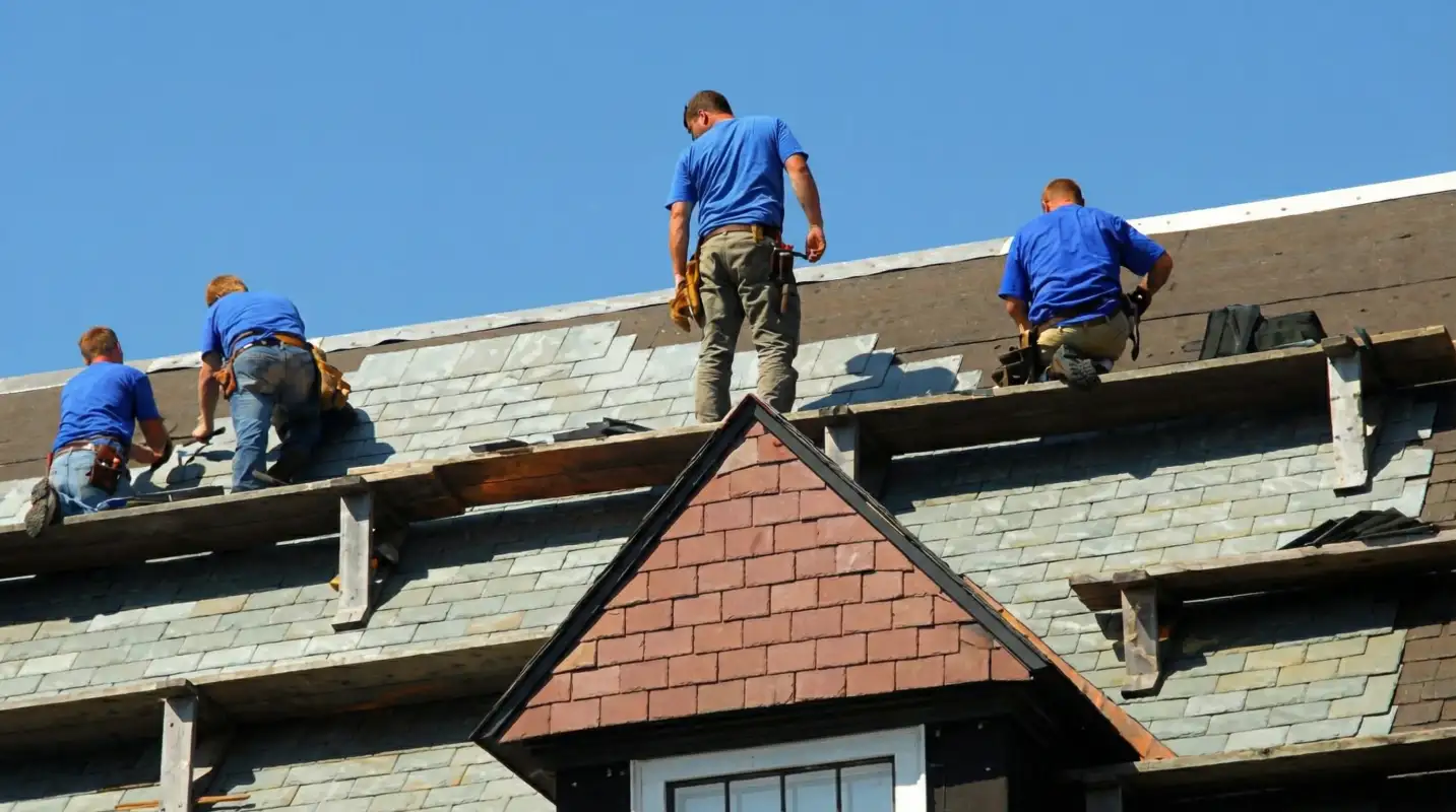 Roof replacement in progress with a team of professional contractors installing new shingles on a residential home in Oklahoma City, OK