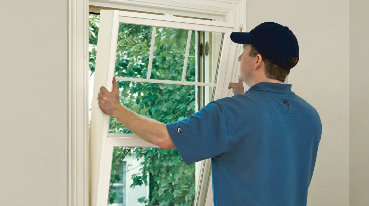 Professional contractors performing a residential window insulation and replacement service in Oklahoma City, OK